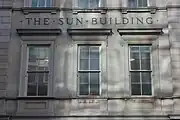 View of The Sun Building name on Broadway