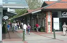 A busy pedestrian walkway through an open-air shopping mall