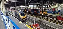 Caledonian Sleeper class 92 (right) Avanti West Coast class 221(left) at London Euston in 2023