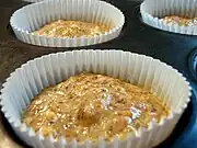 Prepared batter in cupcake wrappers