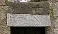 A lintel on the Street of the Knights of Rhodes, featuring the coat of arms of the Knights of Rhodes (in the center), flanked by the coats of arms of Grand Masters Hélion de Villeneuve (r. 1319–1346) and Dieudonné de Gozon (r. 1346–1353), again flanked by the coats of arms of  England and of king Edward III of England, c. 1350.