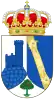 A shield with a crown on top. The shield is divided in three parts, having the left part an image of the watchtower of Torrelodones, colored blue with a white background, the right side has two dragon looking yellow creatures facing each other over a blue background, and on the bottom part is a small green three with red fruits over a white background