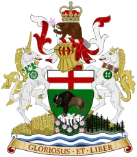 A central shield showing a bison standing on a rock, under a St George's Cross. On top of the shield sits a helmet decorated with a red and white billowing veil. On top of the helmet sits a beaver with a crown on its back, holding a prairie crocus. To the right of the shield is a rearing white unicorn wearing a collar of white and green maple leaves, from which hangs a green cart-wheel pendant. To the left of the shield is a rearing white horse wearing a collar of Indian beadwork, from which hangs a green cycle of life medallion. The animals and shield stand on a mound, with a wheat field beneath the unicorn, prairie crocuses beneath the shield, and spruces beneath the horse. Beneath the mound are white and blue waves, under which is an orange scroll bearing the words "GLORIOSUS ET LIBER"