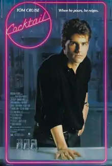 Tom Cruise (as Brian Flanagan) stands behind the bar counter with his right hand on it. Three empty glasses are placed on the counter facing down. The film's logo is written in pink neon colors around a circle with the film's tagline reading "When he pours, he reigns."