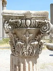 Composite capital whose design includes acanthus leaf, and volute motifs