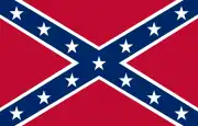 The Confederate battle flag: a blue saltire with white stars, bordered in white, on a red field.