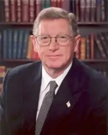 Upper-body portrait of a man in a suit.