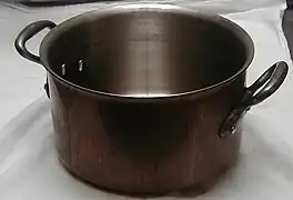 A copper saucepot (stainless lined, with cast iron handles)