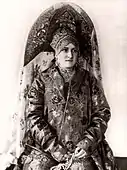 A woman wearing a large, rich, two-horned kokoshnik. 20th century. Photograph.