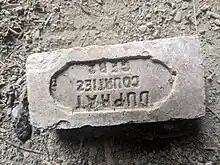 Brick embossed with the writing "Dupart Courties Gers"