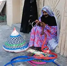 An elderly woman in Oman wearing the Battoulah.