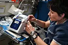 Samantha Cristoforetti demonstrating the first in-space operation of the rHEALTH ONE universal biomedical analyzer as part of Expedition 67