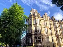 The female statue on tenements overlooking Queen’s Park by William McNicol Whyte