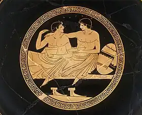 This image has been given the description of a "...courting couple at the symposium." and a "Symposium scene with youths." . Interior of an Attic cup. Artist; Painter from Colmar. Around 500 - 450 BCE. Louvre