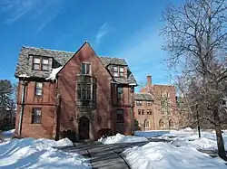 A winged brick building on a clear day, with snow on the ground