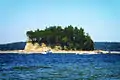 Small butte-shaped island topped with trees