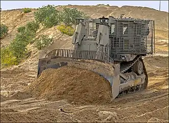 IDF Caterpillar D9R pushing soil (earthworks)