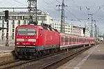 A DB Class 143 with x-Wagen coaches leaves Hauptbahnhof