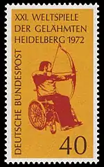 A postage stamp featuring a red image of an archer with drawn bow sat in a wheelchair, on a yellow background