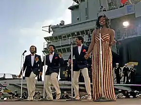 Gladys Knight & the Pips perform aboard the aircraft carrier USS Ranger on November 1, 1981. Left to right: William Guest, Edward Patten, Merald "Bubba" Knight, and Gladys Knight.