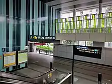 Escalators leading down to Exit A on the left