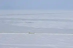 Aerial view of the highway with the Trans-Alaska Pipeline in the background (14 April 2015)