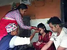 Seniors offering Dashain Tika to junior