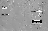 The group of lines running up and down in the image are believed to be deformation bands.  They can be thought of as small faults.