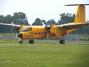 Vortices form at the ends of propeller blades, as seen on this DHC-5 Buffalo.