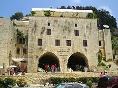 Limestone, fortified residence with arched doorways