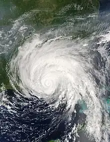 Satellite image of hurricane near of over the Florida Panhandle. The eye of the storm is not well-defined. Convective bands extend to the east and southeast.