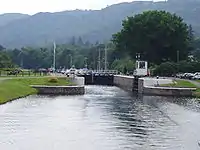 The Dochgarroch Lock along the Caledonian Canal with its lower gates open. The upper gates leading to Loch Dochfour are closed.