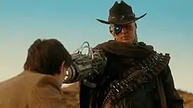 The gunslinger points his weapon at the doctor