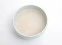 White, opaque liquid in a bowl on a white table