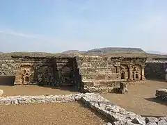 Stupa base at Sirkap, decorated with Hindu, Buddhist and Greek temple fronts.