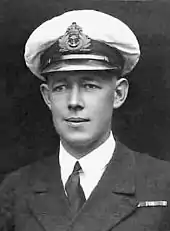 Formal head-and-shoulders portrait of young man in winter naval uniform with peaked cap