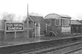 The up platform at Dundrum Station  complete with a sign for St Columba's College on the signal box.