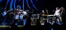 Bob Dylan together with four members of his band onstage.