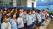 Salvadoran school children singing national anthem