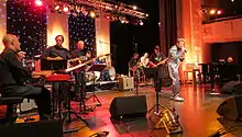 TCB Band 1932 at 12th European Elvis Festival in Bad Nauheim: Glen Hardin (p), Ron Tutt (d), James Burton (g), and Austrian singer Dennis Jale