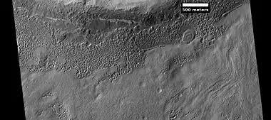 Small, layered structure, as seen by HiRISE under the HiWish program Picture also shows brain terrain forming.