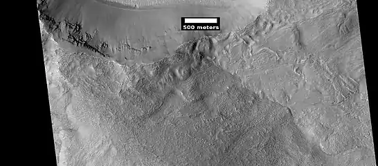 HiRISE image showing smooth mantle covering parts of a crater in the Phaethontis quadrangle.  Along the outer rim of the crater, the mantle is displayed as layers.  This suggests that the mantle was deposited multiple times in the past.  Picture was taken with HiRISE under HiWish program.  The layers are enlarged in the next image.