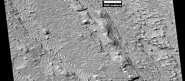 Layered features northeast of Gale Crater, as seen by HiRISE under HiWish program. Layers may be similar to the many layers that are being examined by the Curiosity rover.