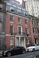  A brick townhouse with slate roof and semicircular entrance portico