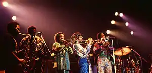 The Phenix Horns in 1982. (L–R): Andrew Woolfolk on saxophone, Don Myrick on saxophone, Louis Satterfield on trombone, Michael Harris on trumpet, and Rahmlee Michael Davis, also on trumpet.