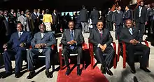 Five presidents seated on chairs in an outdoor scene with sunshine and a red carpet: Yoweri Museveni of Uganda, Mwai Kibaki of Kenya, Paul Kagame of Rwanda, Jakaya Kikwete of Tanzania and Pierre Nkurunziza of Burundi