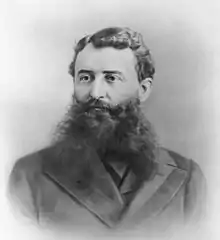 black-and-white 19th-century photo of a man with a bushy beard