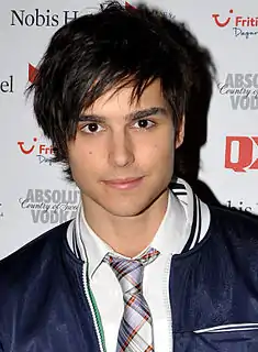 Young man with touseled dark hair and a necktie