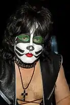 Singer posing in the cat makeup