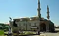 Side view of the mosque, showing the domed prayer hall preceded by a portico (right)